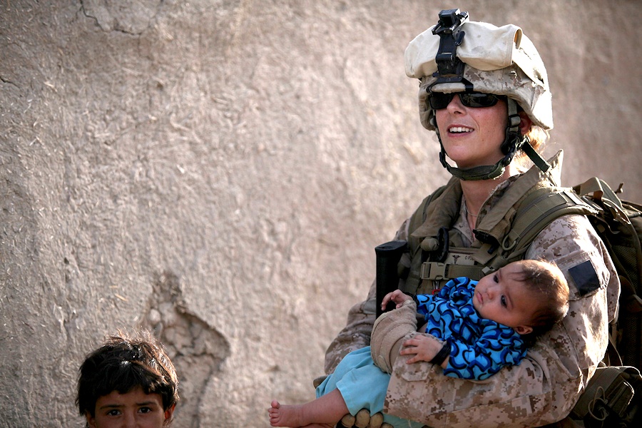U.S. Navy Petty Officer 2nd Class Claire Ballante holds an Afghan child during a patrol with Marines from 1st Battalion, 2nd Marine Regiment in Musa Qa'leh, Afghanistan, Aug. 3, 2010. Ballante is part of a female engagement team that is patrolling local compounds to assess possible home damage caused by aircraft landing at Forward Operating Base Musa Qala. (DoD photo by Cpl. Lindsay L. Sayres, U.S. Marine Corps/Released)